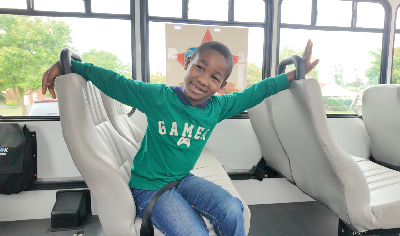 kid riding radar bus